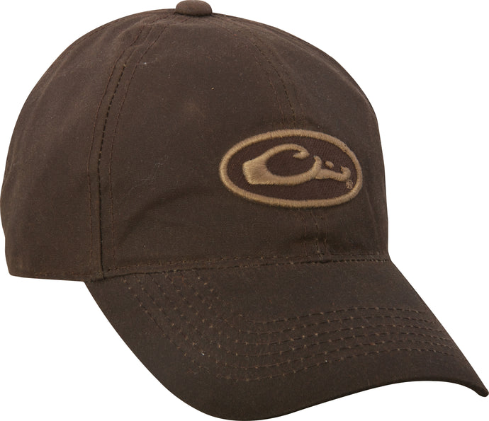 A mid-profile, six-panel brown hat with a Drake Waterfowl logo patch on the front. Made of 100% cotton canvas fabric. Features a self fabric closure with brass slide adjustment.