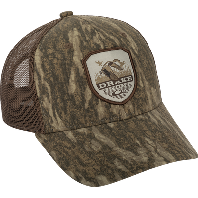 Vintage Badge Mesh Back Cap with Drake logo, a hat with a logo on it. Classic trucker style with a duck shield patch on a camouflage uniform.