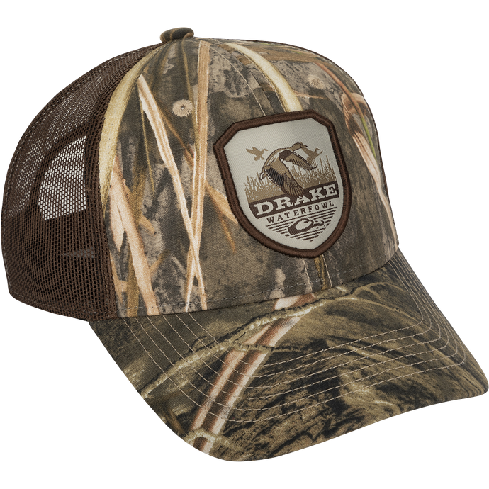 A vintage duck shield patch on a classic trucker mesh-back cap with the Drake logo, a go-to part of your outfit for any occasion.