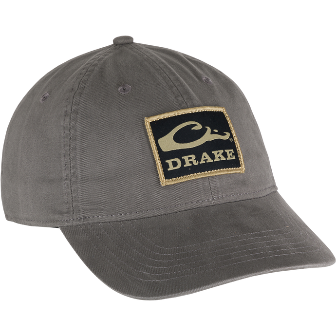 Cotton Twill Patch Cap with a grey hat featuring a logo. Low profile, contoured bill, and brass buckle back strap for a comfy fit. 