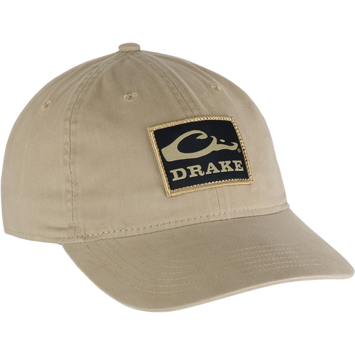 Cotton Twill Patch Cap - A tan hat with a logo patch, low profile, contoured bill, and brass buckle back strap. 
