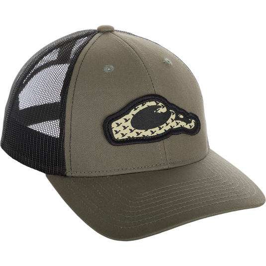 A green trucker cap with a Drake head logo and migrating ducks flying through it. Stylish, breathable, and comfortable for everyday wear.