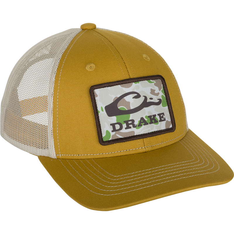 A close-up of the Old School Patch 2.0 Mesh Back Cap, featuring a yellow hat with a logo patch.