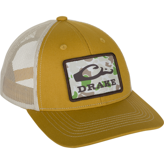 A close-up of the Old School Patch 2.0 Mesh Back Cap, featuring a yellow hat with a logo patch.