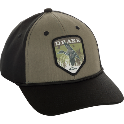 A Drake In-Flight Badge Cap with a duck patch on it, made of 100% cotton panels and visor. Adjustable snapback for a custom fit.