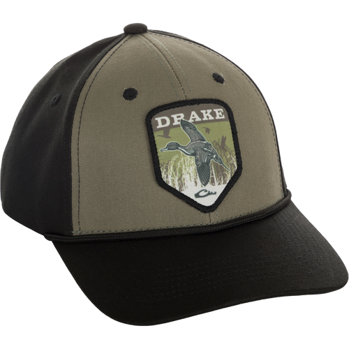A Drake In-Flight Badge Cap with a duck patch on it, made of 100% cotton panels and visor. Adjustable snapback for a custom fit.