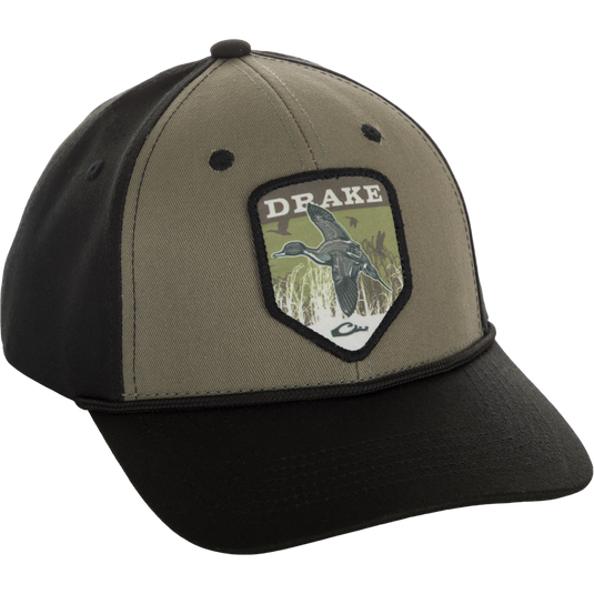 A Drake In-Flight Badge Cap with a duck patch on it, made of 100% cotton panels and visor. Adjustable snapback for a custom fit.