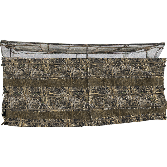 A close-up of the Ghillie Clubhouse 6-Man Blind with No-Shadow Dual Action Top, featuring a hay-covered fence and a net.