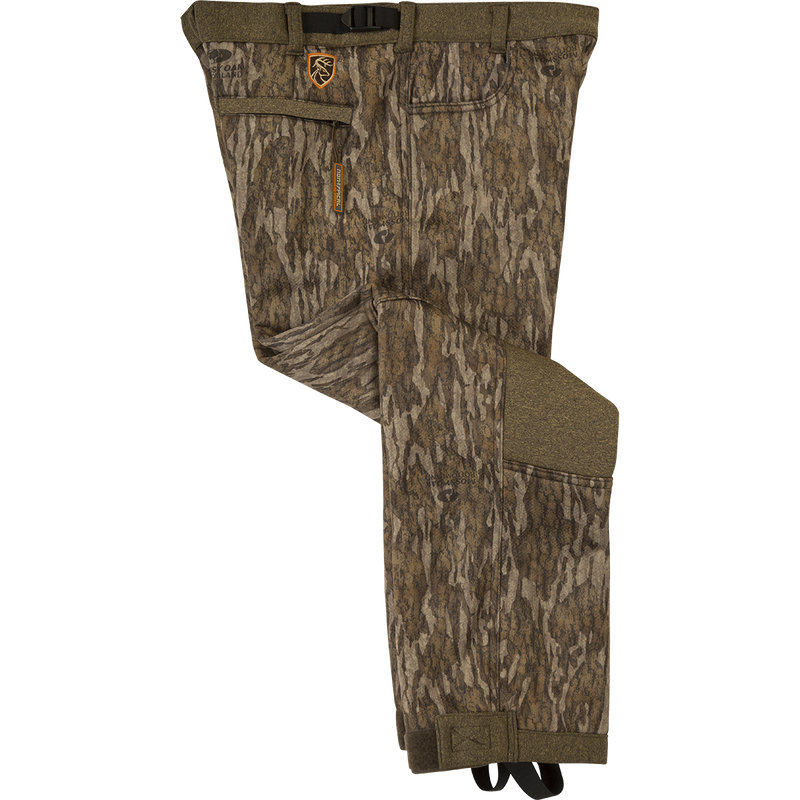 Youth Silencer Pant With Agion Active XL: A pair of quiet and comfortable camouflage pants for Mid to Late Season deer hunting. Made of soft-shell fabric with a micro-fleece lining for warmth and comfort. Features scent control technology, adjustable waist, hook and loop ankle, and elastic foot stirrups.