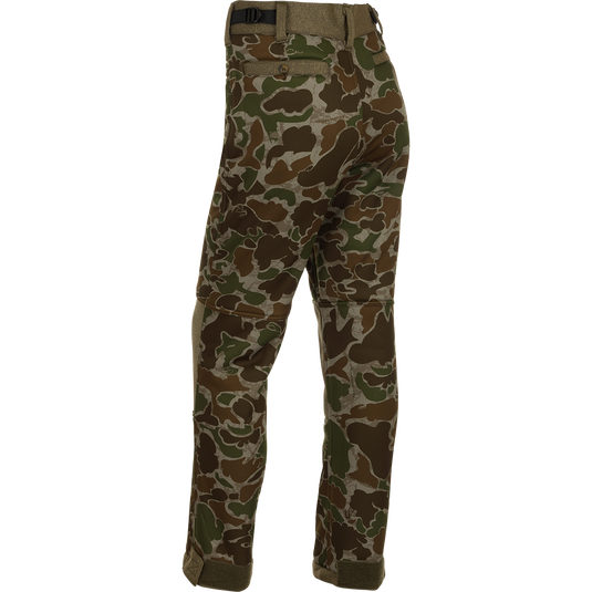 A pair of camouflage pants designed for quiet and comfortable hunting. Made with soft-shell fabric and a micro-fleece lining for warmth and comfort. Features Agion Active XL® scent control technology, adjustable waist, hook and loop ankle, and elastic foot stirrups. Perfect for mid to late season deer stands.