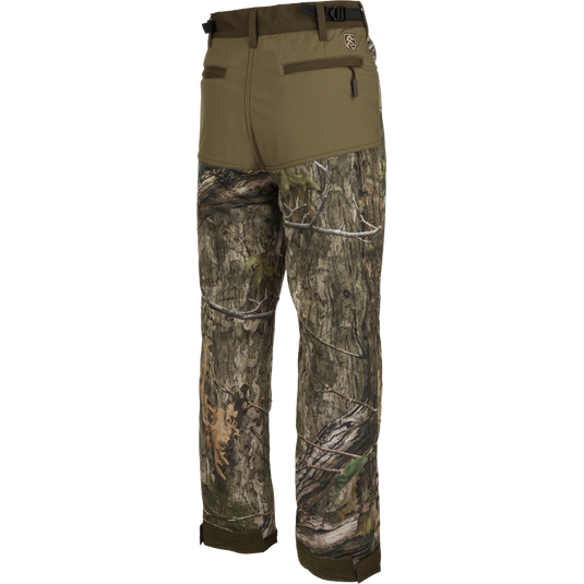 A pair of Standstill Windproof Pants with Agion Active XL®, perfect for late-season hunts. Made of durable fabric with scent control technology. Features adjustable waist and cuffs, front slash pockets, cargo pockets, and rear pockets. Essential for harsh cold and winds.