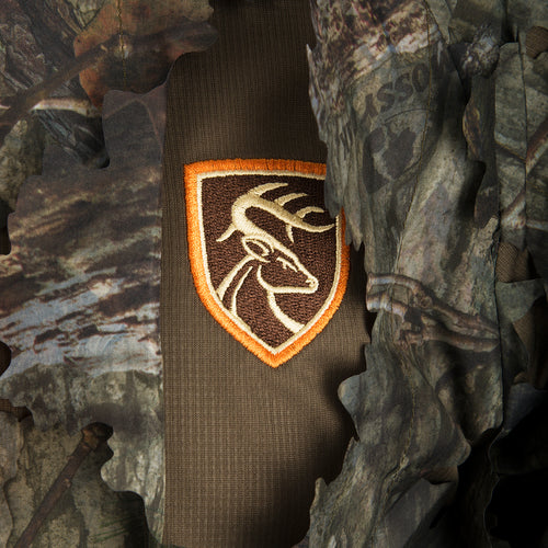 3D Leafy Jacket with Agion Active XL, a close-up of a brown and orange deer head patch on a military uniform armor.