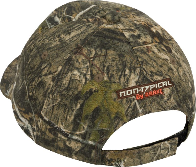 Non-Typical 5-Panel Cap: Camouflage hat with logo, made of 100% cotton twill fabric. Features five-panel construction, mid-profile fit, and structured front panel. Adjustable with hook & loop closure.