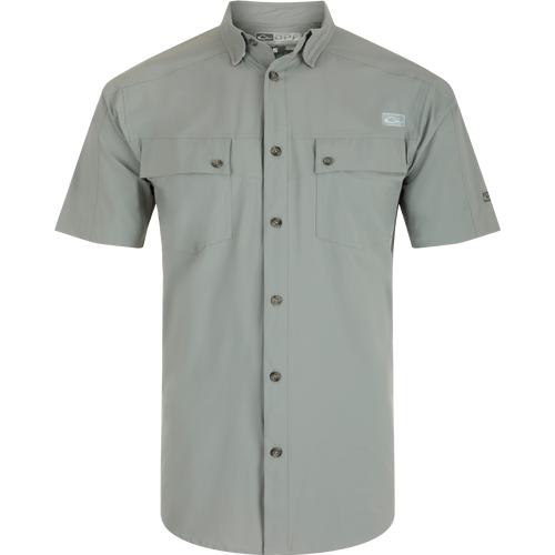 A close-up of the Performance Mesh Paneled Short Sleeve Shirt, featuring a button-down collar, laser-punched mesh back panels for ventilation, and two chest pockets. Lightweight, moisture-wicking fabric with UPF 50 sun protection.