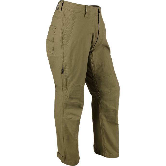 A pair of khaki Canvas Waterfowler's Pants made from lightweight, garment-washed cotton canvas. Ideal for wearing around camp or on the farm. Features include hook & loop ankle cuffs, rear pockets, side storage pocket, and a zippered fly.
