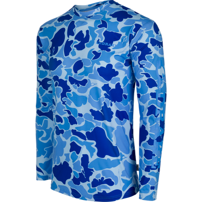 A high-performance Drake Performance Crew shirt with a blue and white camouflage pattern. Lightweight, moisture-wicking, and quick-drying fabric with UPF 50 sun protection. Perfect for outdoor activities like hunting, fishing, and more.