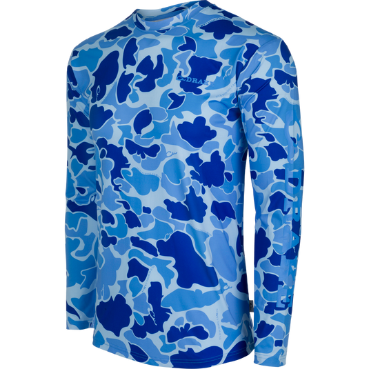 A high-performance Drake Performance Crew shirt with a blue and white camouflage pattern. Lightweight, moisture-wicking, and quick-drying fabric with UPF 50 sun protection. Perfect for outdoor activities like hunting, fishing, and more.