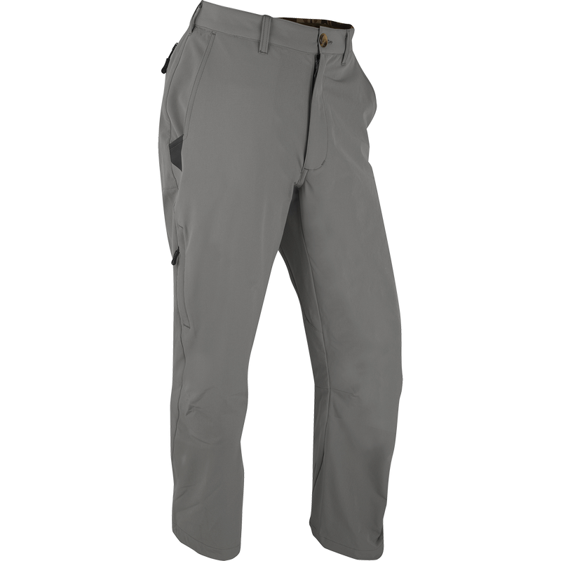 A pair of lightweight and durable Stretch Tech Pants with 4-way stretch and moisture-wicking qualities. Features gusseted crotch, articulated knee, YKK zippers, side stash pockets, and two cargo pockets. Perfect for outdoor activities.