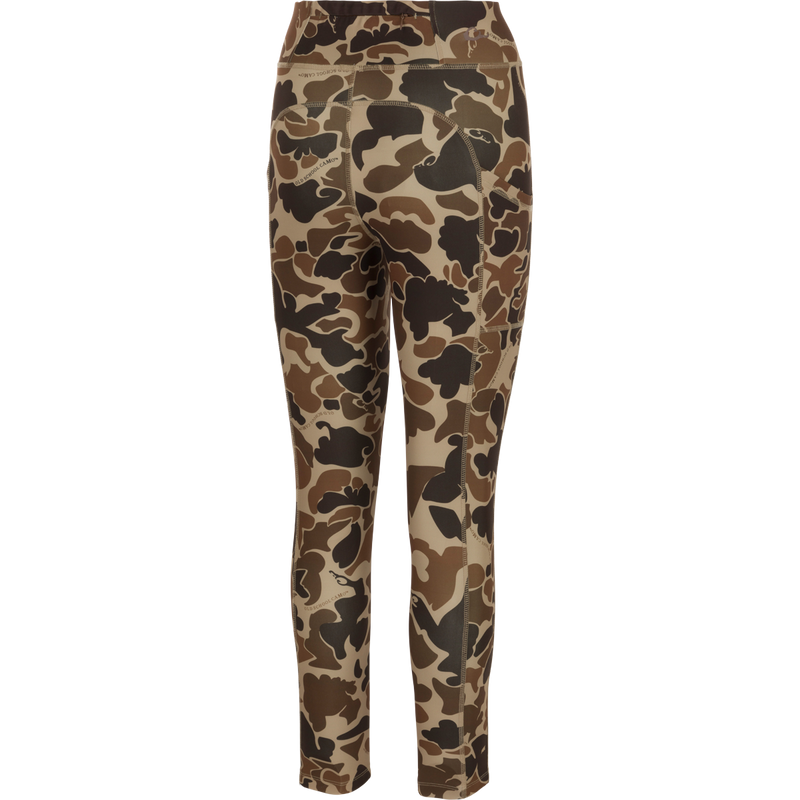 A versatile Women's Commando Printed Legging with Old School Camo pattern. High-performance 4-way stretch fabric, quick drying, moisture-wicking. Features a 4-inch waistband, back zippered pocket, and side stash pockets. Perfect for your next adventure.