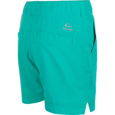 A pair of women's Commando Lined Shorts with a logo on the side, featuring clean lines, scalloped hem, and multiple pockets. 7
