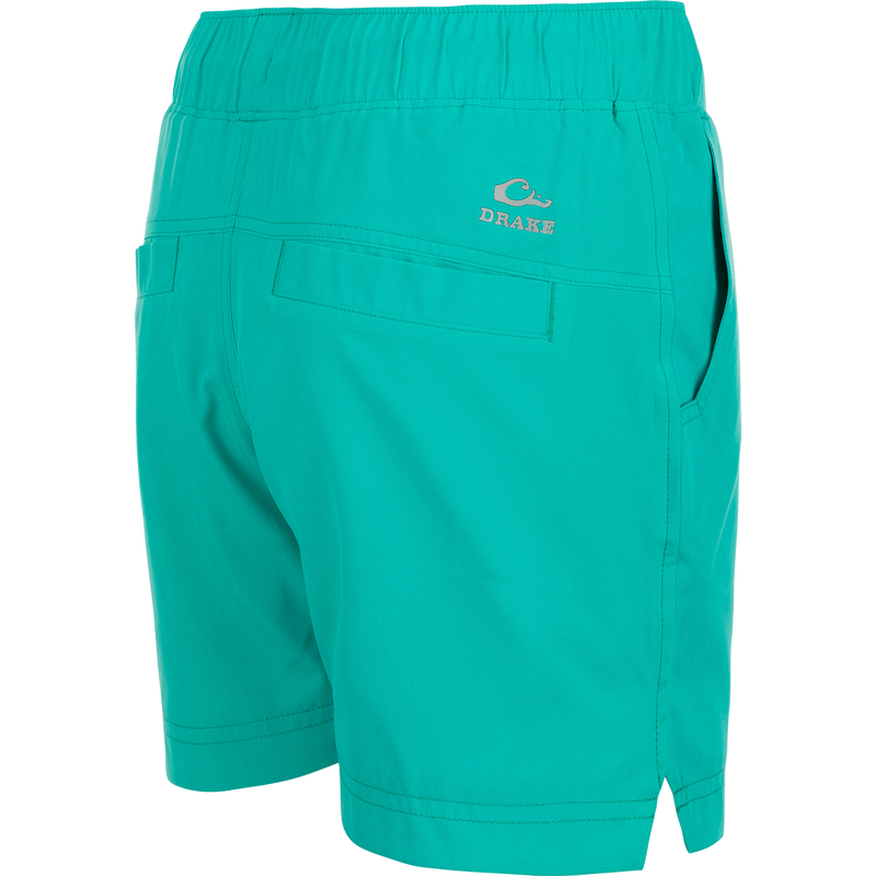 A pair of women's Commando Lined Shorts with a logo on the side, featuring clean lines, scalloped hem, and multiple pockets. 7