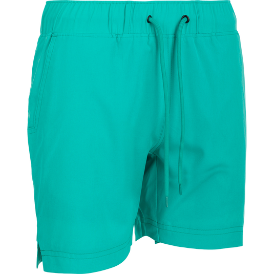 A pair of women's Commando Lined Shorts with a built-in liner, 7" inseam, and 4-way stretch. Features include front slash and back mesh pockets, side notch hem, and elastic waist with drawstring. Ideal for gym or beach wear.
