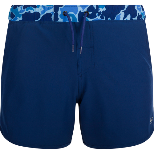 A versatile blue and white swim short with a camo print, featuring a built-in liner, scalloped hem, and multiple pockets. Ideal for playground or beach wear.
