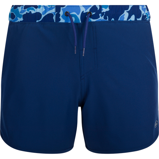 A versatile blue and white swim short with a camo print, featuring a built-in liner, scalloped hem, and multiple pockets. Ideal for playground or beach wear.