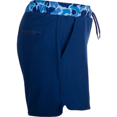 A versatile blue shorts with a camo print, featuring a 5 inseam and built-in liner for comfort. Made with quick-drying, moisture-wicking fabric and a durable water-resistant finish. Includes front and back pockets with hidden zippers. Perfect for playground or beach wear.