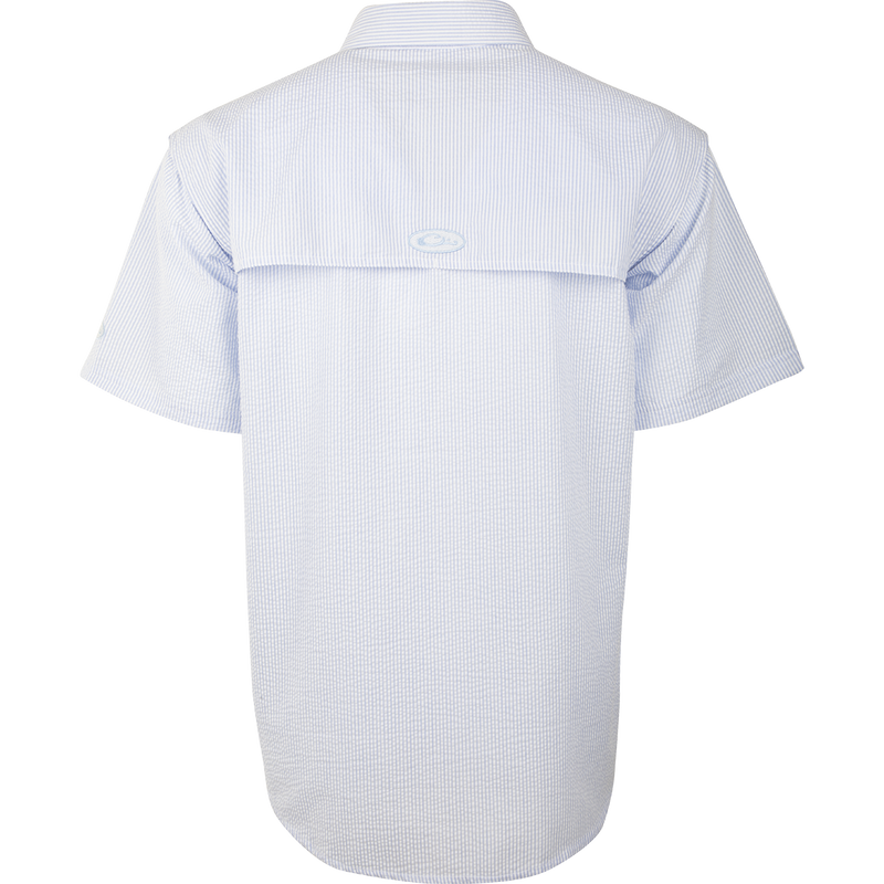 A Seersucker Wingshooter's Shirt with a button-down collar, heat vents, and multiple pockets. Made of StayCool™ fabric for breathability and wicking benefits. Perfect for spring and summer outings.