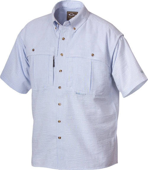 A youth seersucker shirt with blue and white stripes, featuring a collar, button-down front, and a Magnattach chest pocket. Made of breathable StayCool fabric with front and back heat vents. Perfect for hunting and outdoor activities.