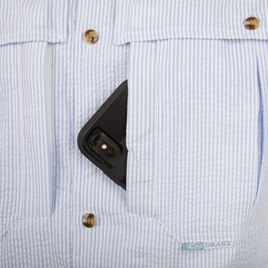 Seersucker Wingshooter's Shirt S/S - Blue: A cell phone in a shirt pocket, close-up of a phone, camera lens, and button.