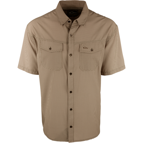 A brown checkered shirt with a four-way stretch fabric, moisture-wicking, and two chest pockets with button flaps. Traveler's Check Shirt S/S from Drake Waterfowl.