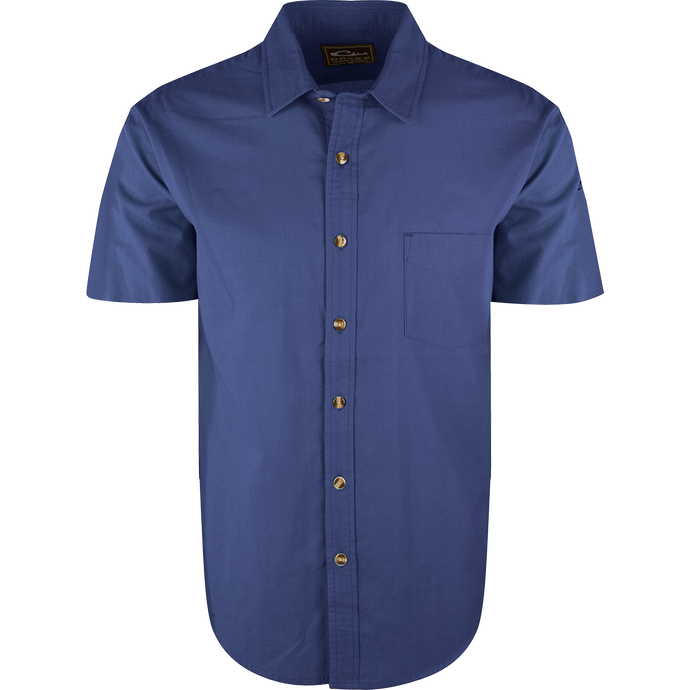 A blue NeverTuck Shirt S/S with buttons, made of soft-washed 100% cotton. Features include an open collar style and a left chest pocket. 