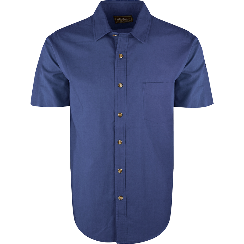 A blue NeverTuck Shirt S/S with buttons, made of soft-washed 100% cotton. Features include an open collar style and a left chest pocket. 