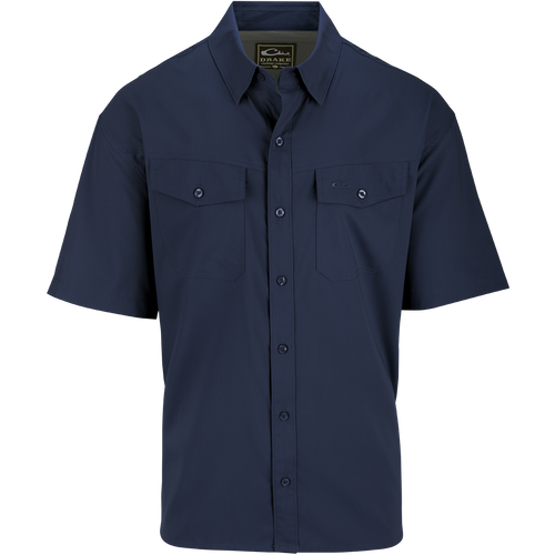 A blue short sleeved shirt with hidden button-down collar, chest pockets, and split tail hem. Made of 100% Polyester dobby fabric with UPF30 sun protection. Versatile for any season.