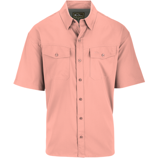 A close-up of the Traveler's Solid Dobby Short Sleeve Shirt, featuring a hidden button-down collar, button-through chest pockets, and a split tail hem. Made with 100% Polyester textured dobby fabric, this shirt is lightweight at 79 GSM, moisture-wicking, and offers UPF30 sun protection. Perfect for both dressed-up and casual occasions.