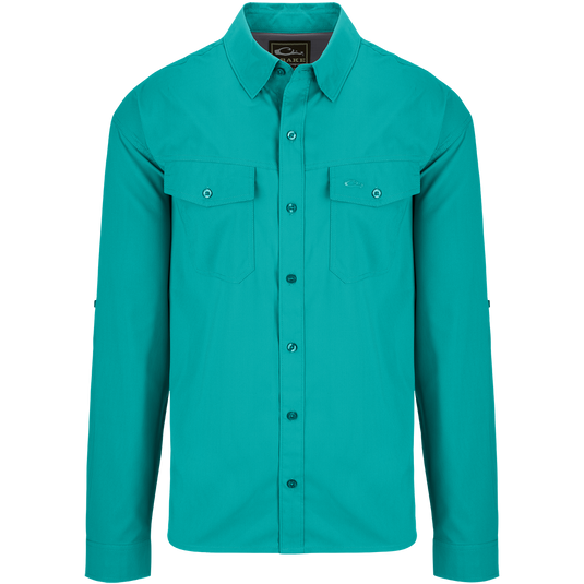 Traveler's Solid Dobby Shirt L/S: A classic fit long sleeve shirt with hidden button-down collar, chest pockets, and split tail hem. Made of featherweight polyester fabric with UPF30 sun protection. Versatile for any season.