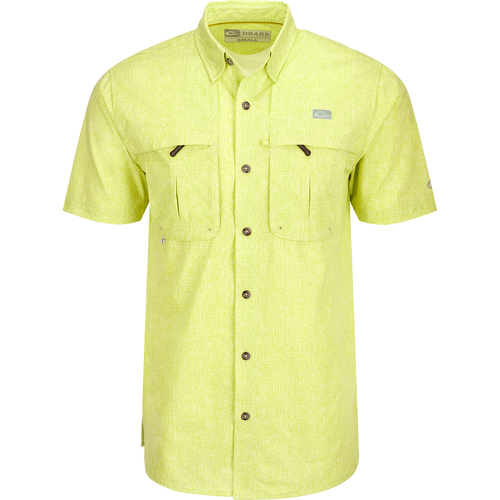 Heritage Heather Shirt S/S: A yellow shirt with pockets, button-down collar, and mesh ventilation. Lightweight, moisture-wicking, and UPF30 sun protection.