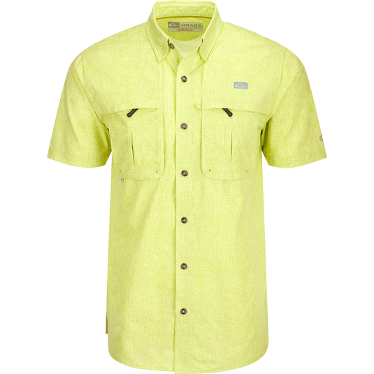 Heritage Heather Shirt S/S: A yellow shirt with pockets, button-down collar, and mesh ventilation. Lightweight, moisture-wicking, and UPF30 sun protection.