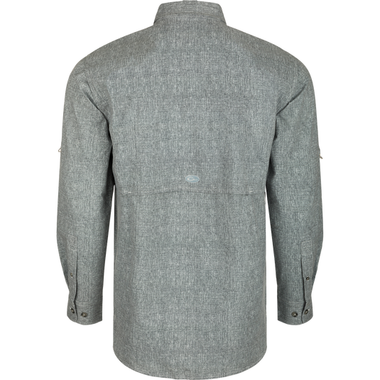 Heritage Heather Shirt L/S: A grey shirt with a back view, featuring a cape back with mesh ventilation, hidden button-down collar, and two front chest pockets. Lightweight, moisture-wicking fabric with UPF30 sun protection. Perfect for performance on the water or at the office.