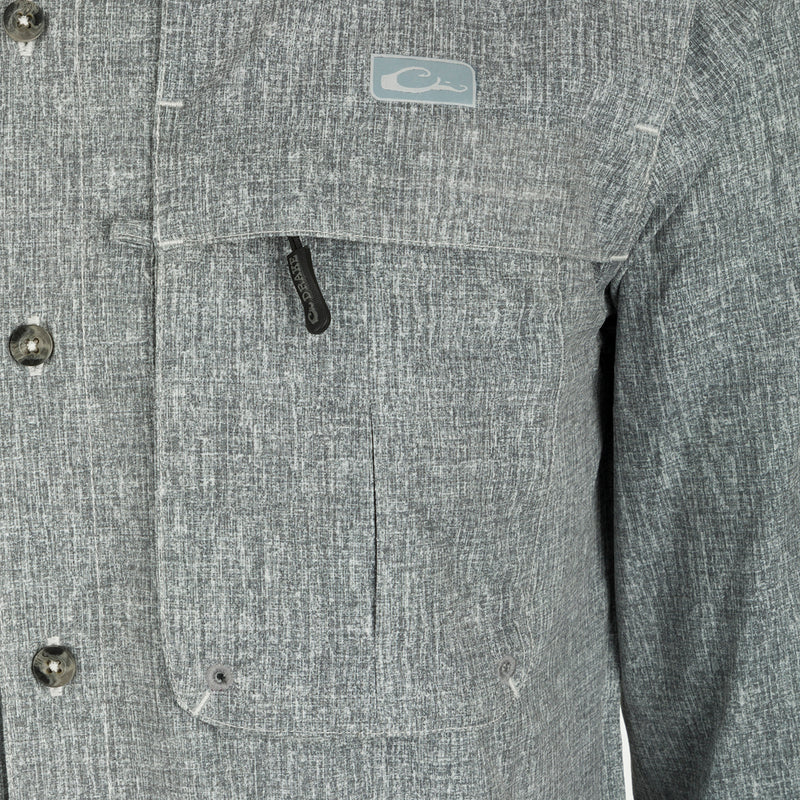 A close-up of the Heritage Heather Shirt L/S, showcasing its button-down collar, chest pockets, and split tail hem.