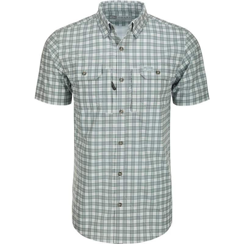 Hunter Creek Check Plaid Shirt S/S: A close-up of a grey and white plaid shirt with a hidden button-down collar and two button-through chest pockets.