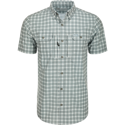 Hunter Creek Check Plaid Shirt S/S: A close-up of a grey and white plaid shirt with a hidden button-down collar and two button-through chest pockets.
