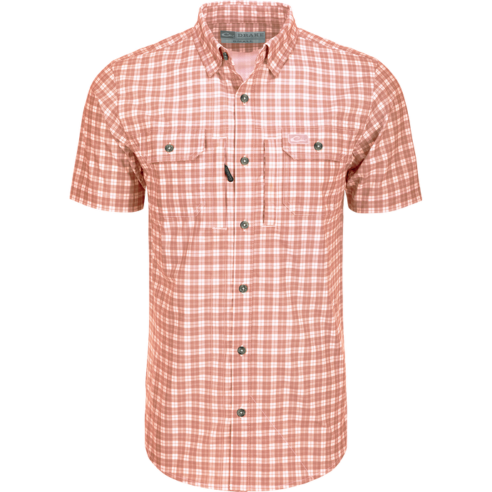A red and white plaid shirt with hidden button-down collar, vented back cape, and two chest pockets. Lightweight and moisture-wicking for comfort.