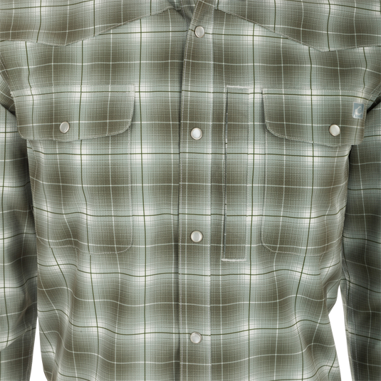 Cinco Ranch Plaid Long Sleeve Shirt - Close-up of shirt with button and plaid fabric pattern. Lightweight, breathable, and equipped with UPF 30 sun protection, moisture-wicking, and quick-drying capabilities. Hidden button-down collar and faux pearl snap buttons enhance the look. Adjustable roll-up sleeves and tab holders for any adventure.