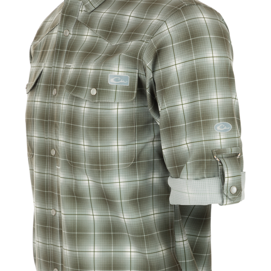 Cinco Ranch Plaid Long Sleeve Shirt, a mannequin wearing a button-up shirt with a hidden collar and faux pearl snap buttons. Lightweight and breathable, with UPF 30 sun protection and moisture-wicking capabilities. Ready for any adventure!