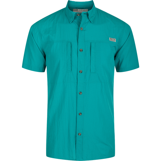 Classic Seersucker Minicheck Shirt: A close-up of a green shirt with buttons, featuring a hidden button-down collar and a zippered chest pocket.
