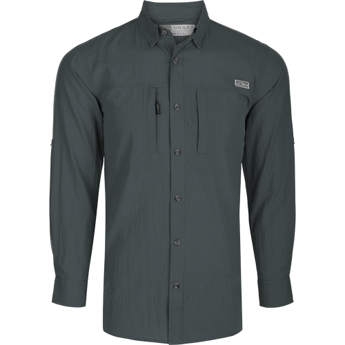 Classic Seersucker Minicheck Shirt L/S: A black long-sleeved shirt with buttons, featuring a hidden zippered chest pocket and a magnet closure on the other pocket. Made from a soft and featherweight performance fabric with UPF30 sun protection. Vented cape back and split tail hem for added ventilation and versatility. Perfect for hunting, fishing, and outdoor activities.
