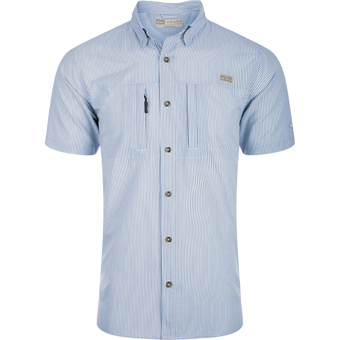Classic Seersucker Stripe Shirt S/S: A button-down shirt with blue and white stripes, made from performance fabric for moisture-wicking and sun protection. Features include hidden zippered chest pocket, Magnattach™ closure, vented cape back, and split tail hem.